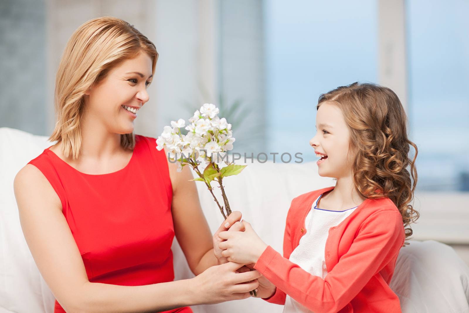 happy mother and daughter with flowers by dolgachov