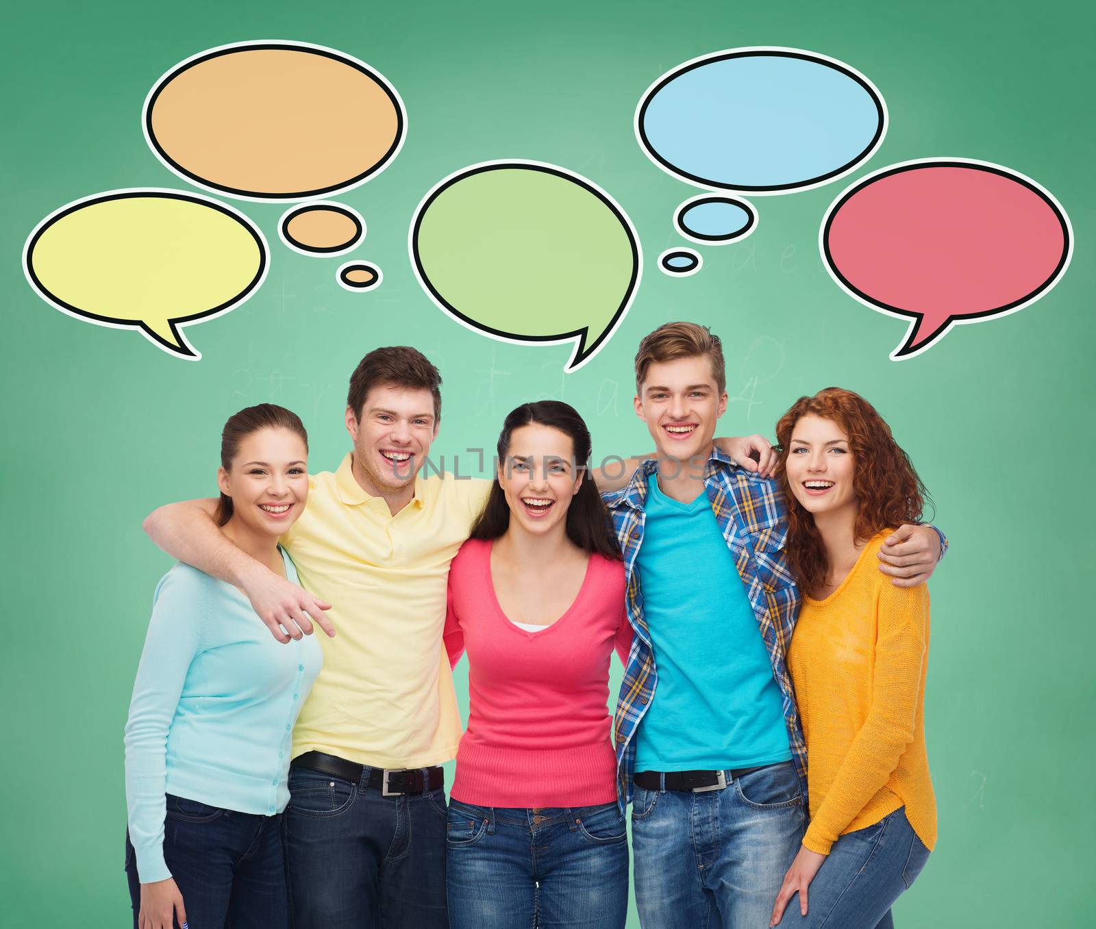 school, education, communication and people concept - group of smiling teenagers over green board background with text bubbles