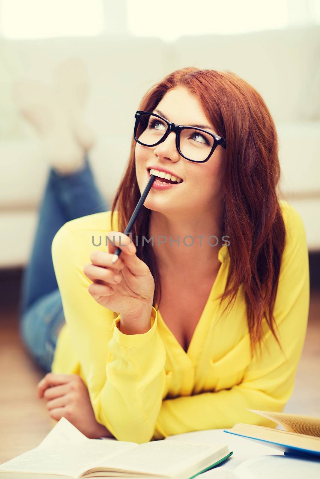 education and home concept - smiling student girl in eyeglasses reading books at home