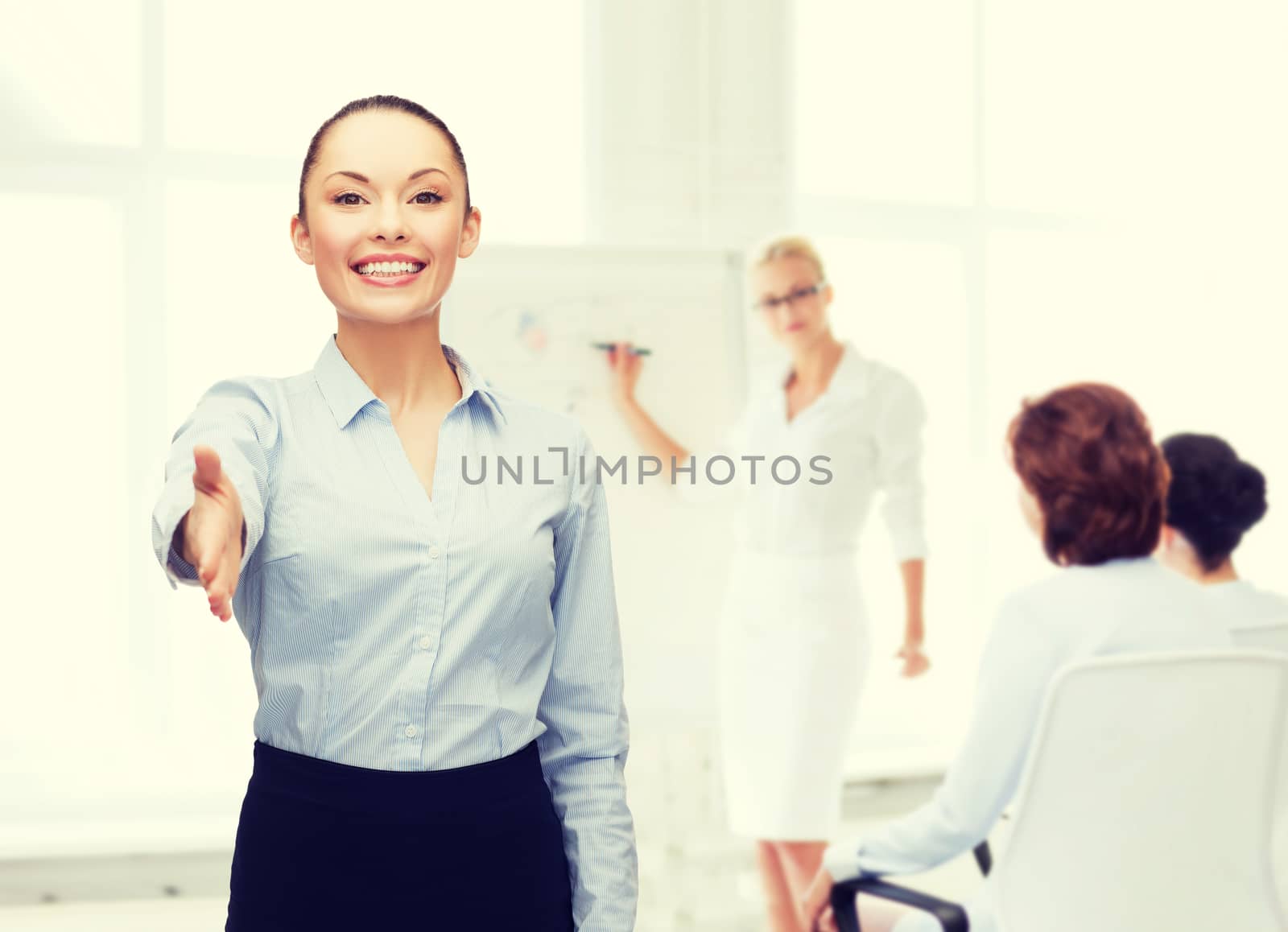 businesswoman with opened hand ready for handshake by dolgachov