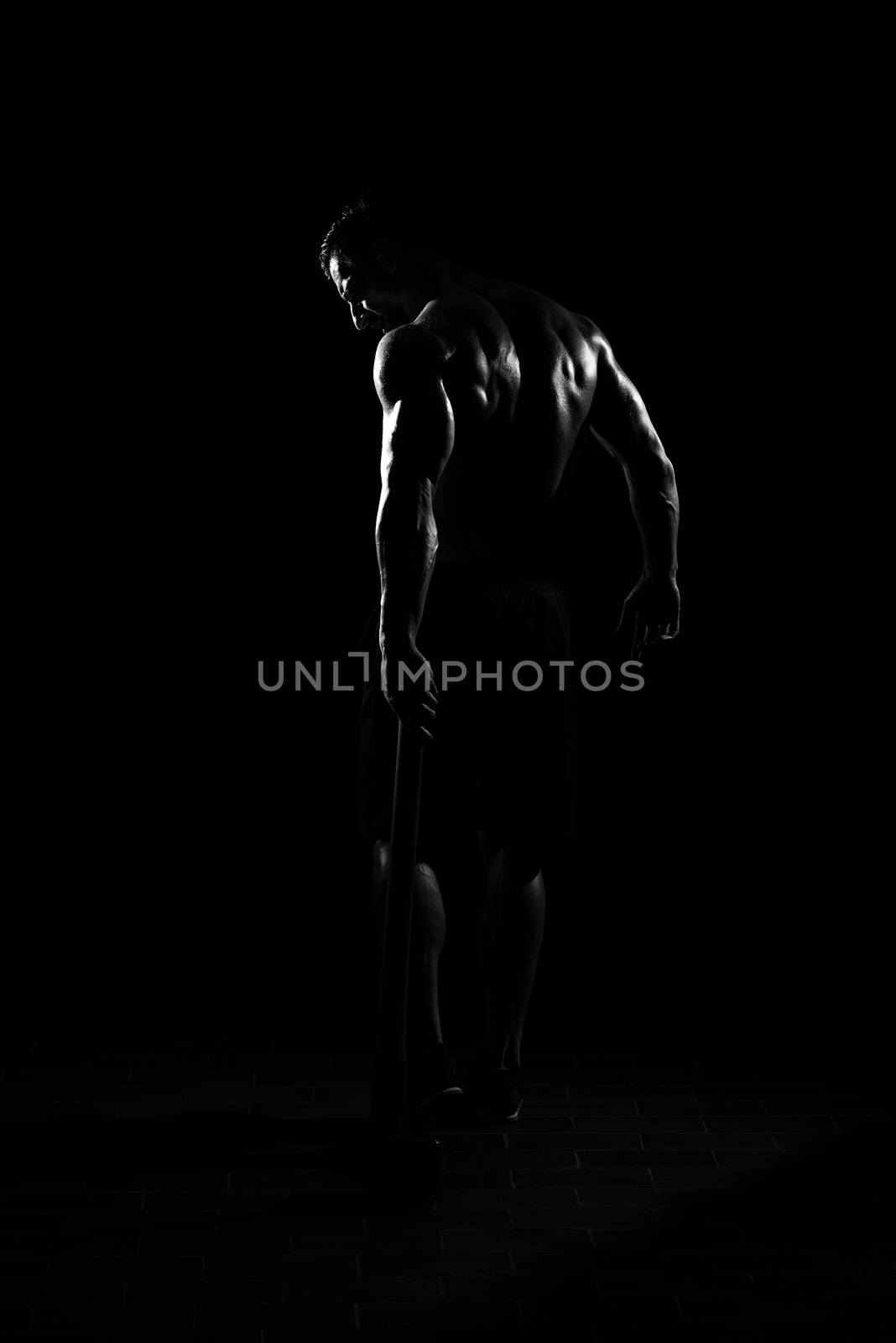 Man Walking Alone With Hammer In Dark Room