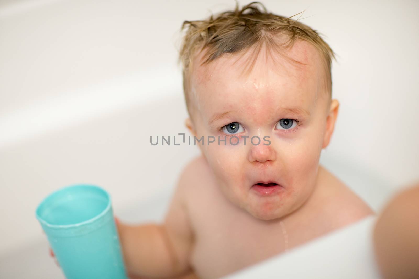 Little guy makes one interesting face while getting a bath