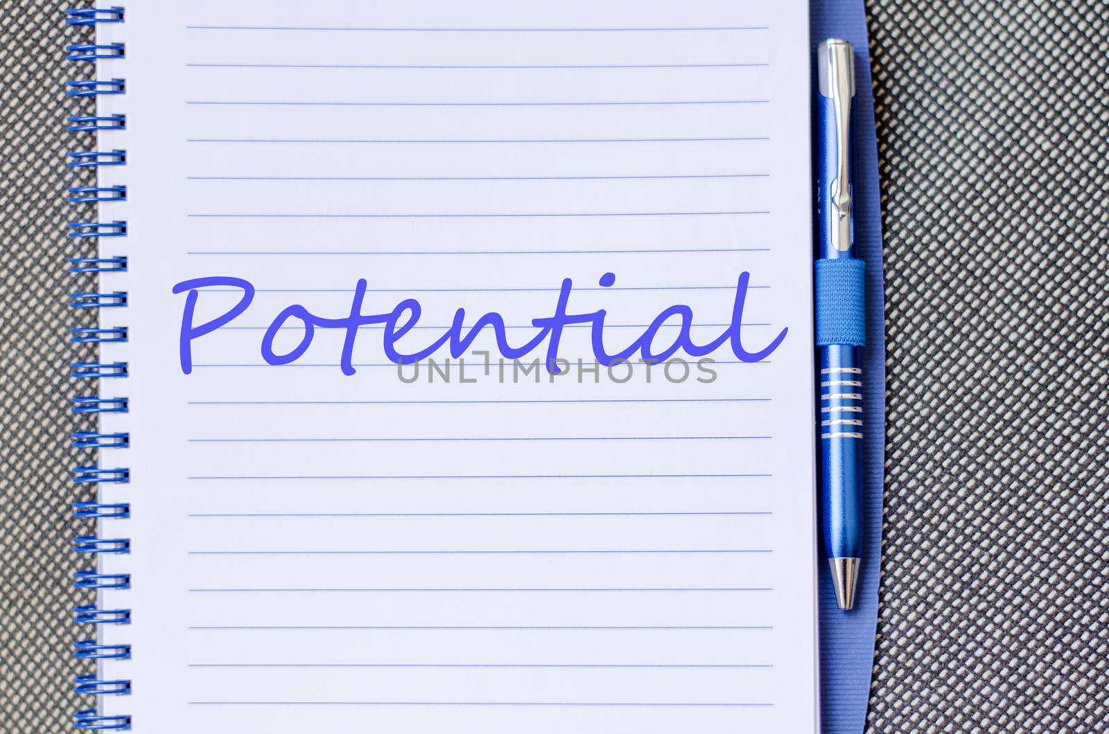 Notepad and pen on wooden background and text concept