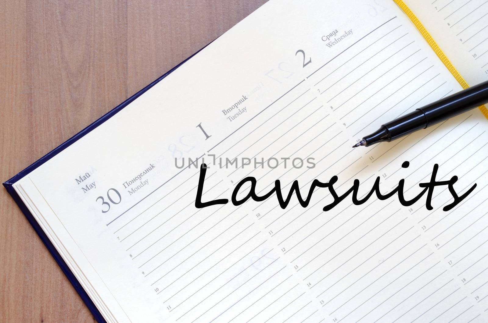 Notepad and pen on wooden background and text concept