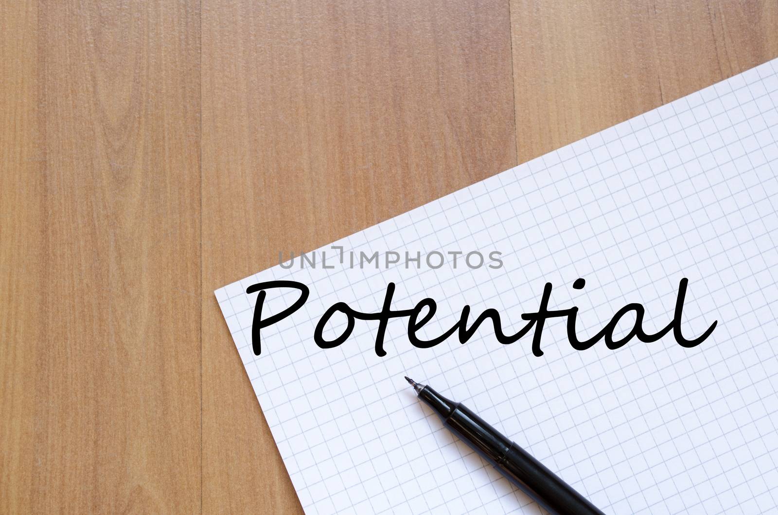 Notepad and pen on wooden background and text concept