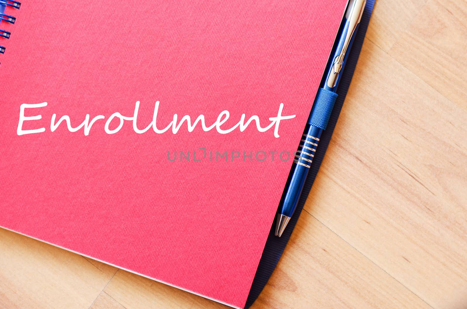 Notepad and pen on wooden background and text concept