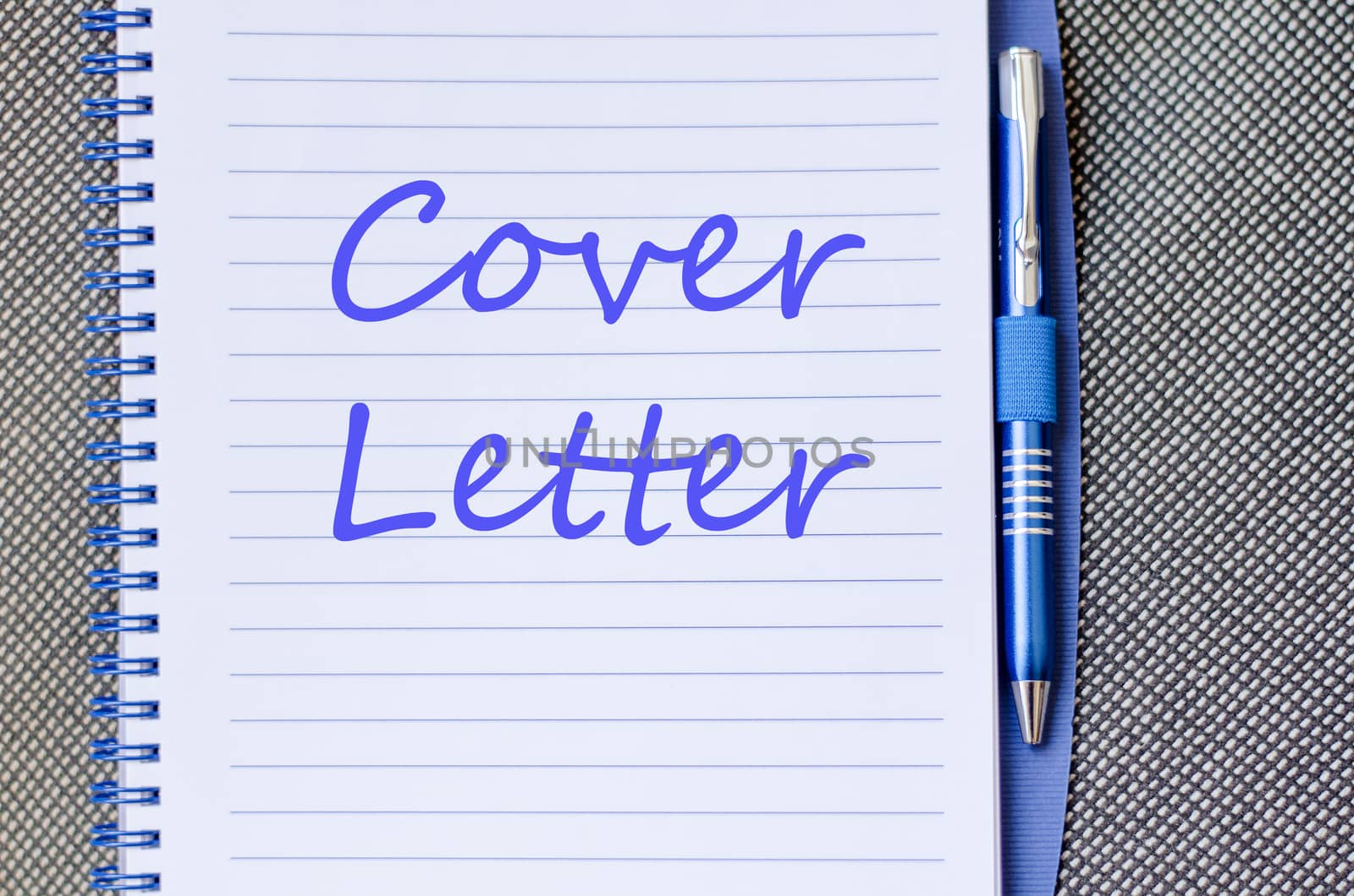 Notepad and pen on wooden background and text concept