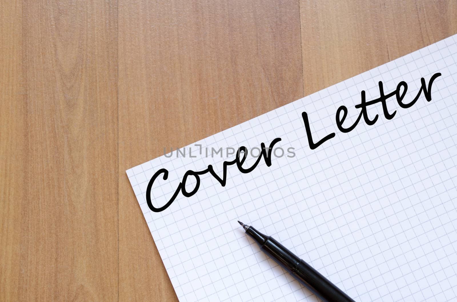 Notepad and pen on wooden background and text concept