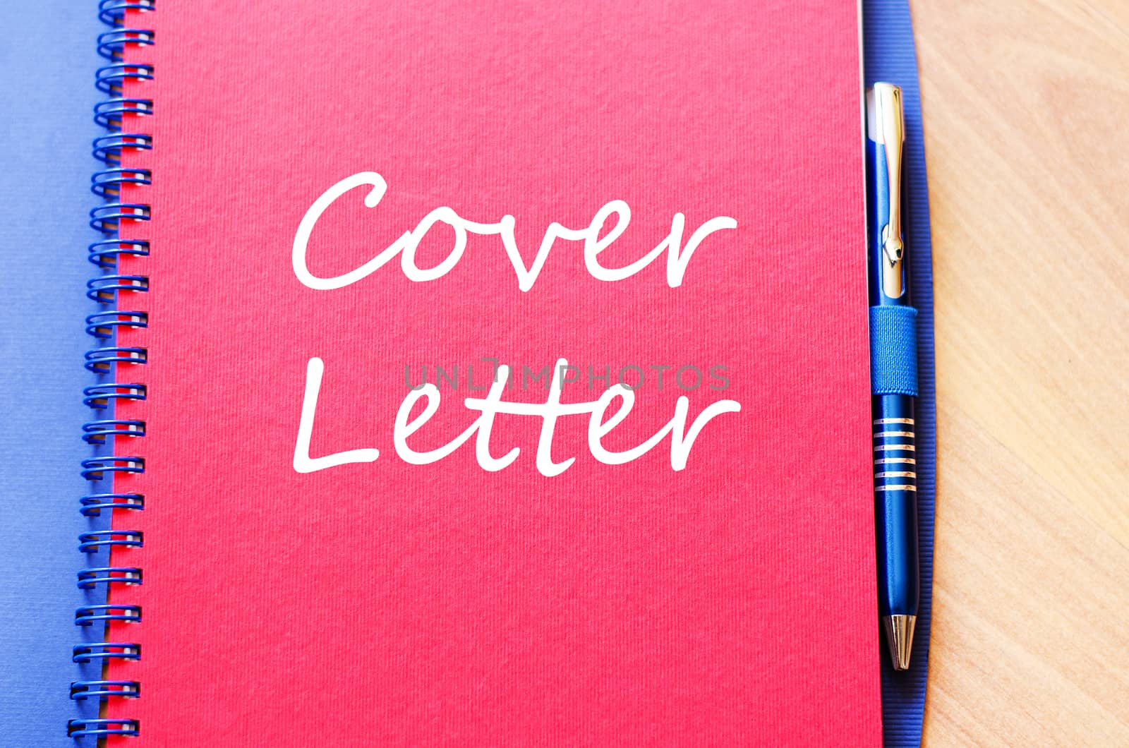Notepad and pen on wooden background and text concept