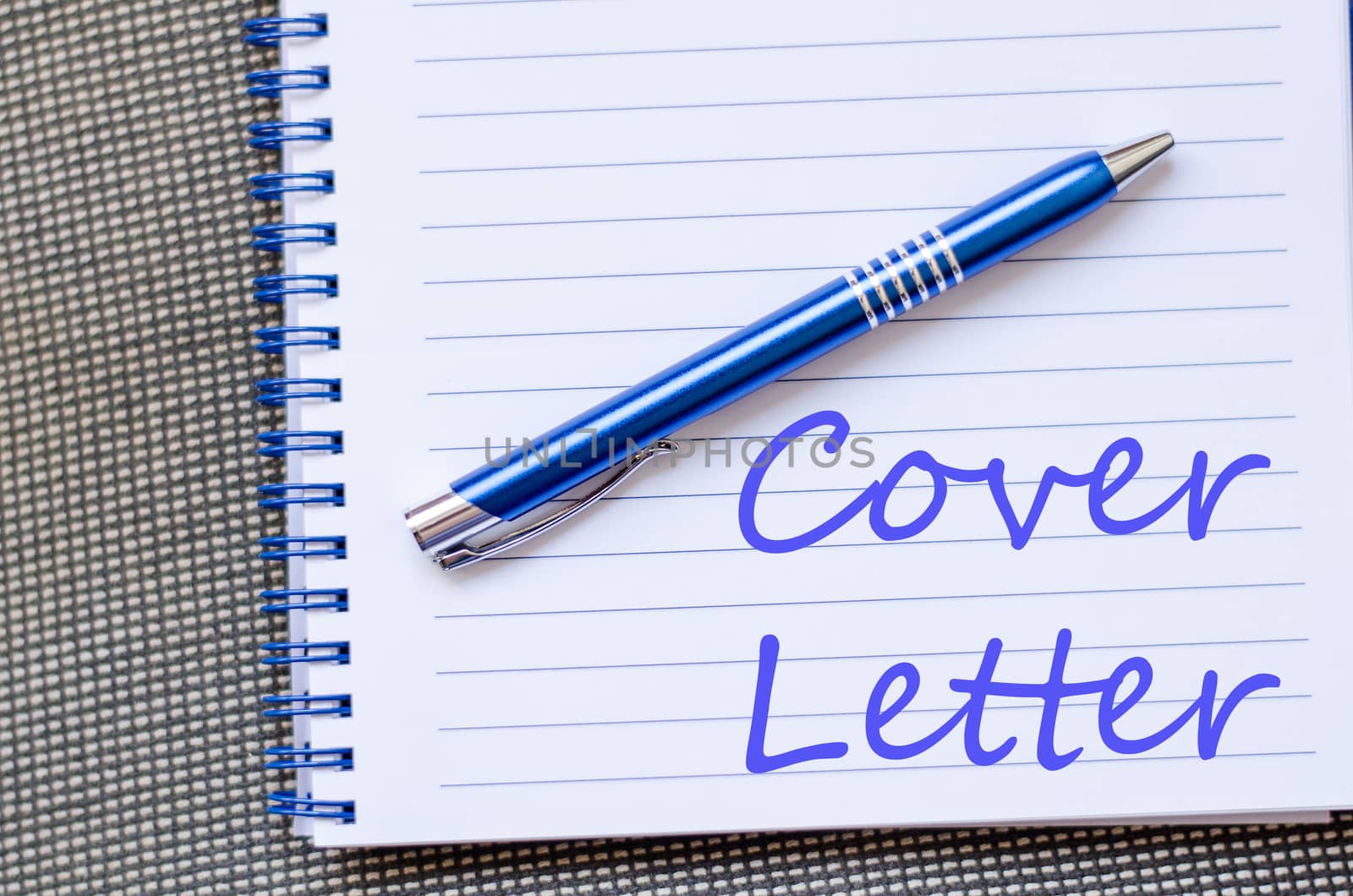 Notepad and pen on wooden background and text concept