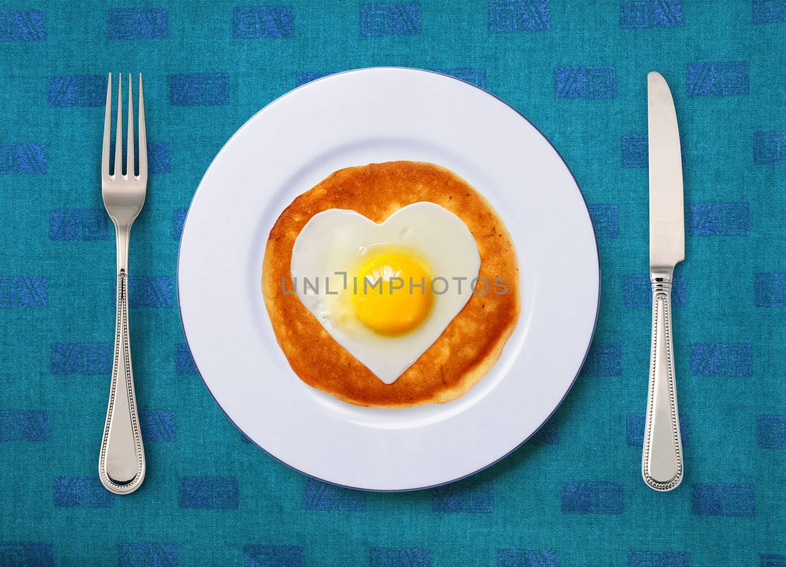 festive snack from scrambled egg on white plate with knife and fork