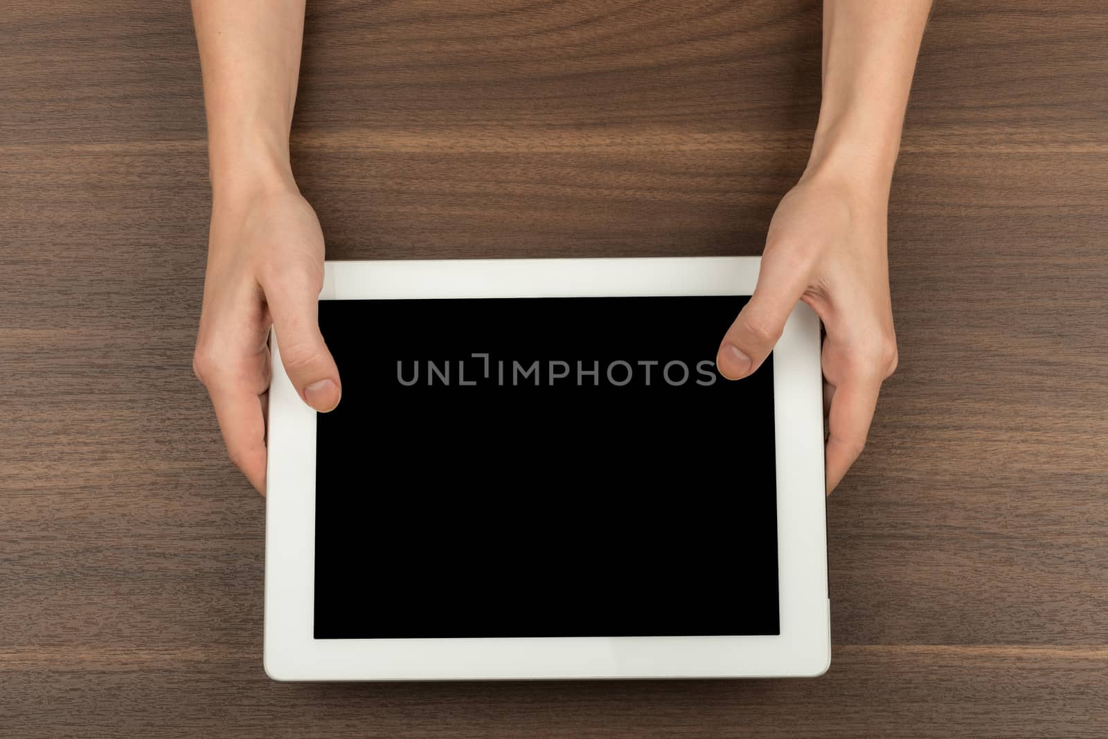 Humans hands holding tablet by cherezoff