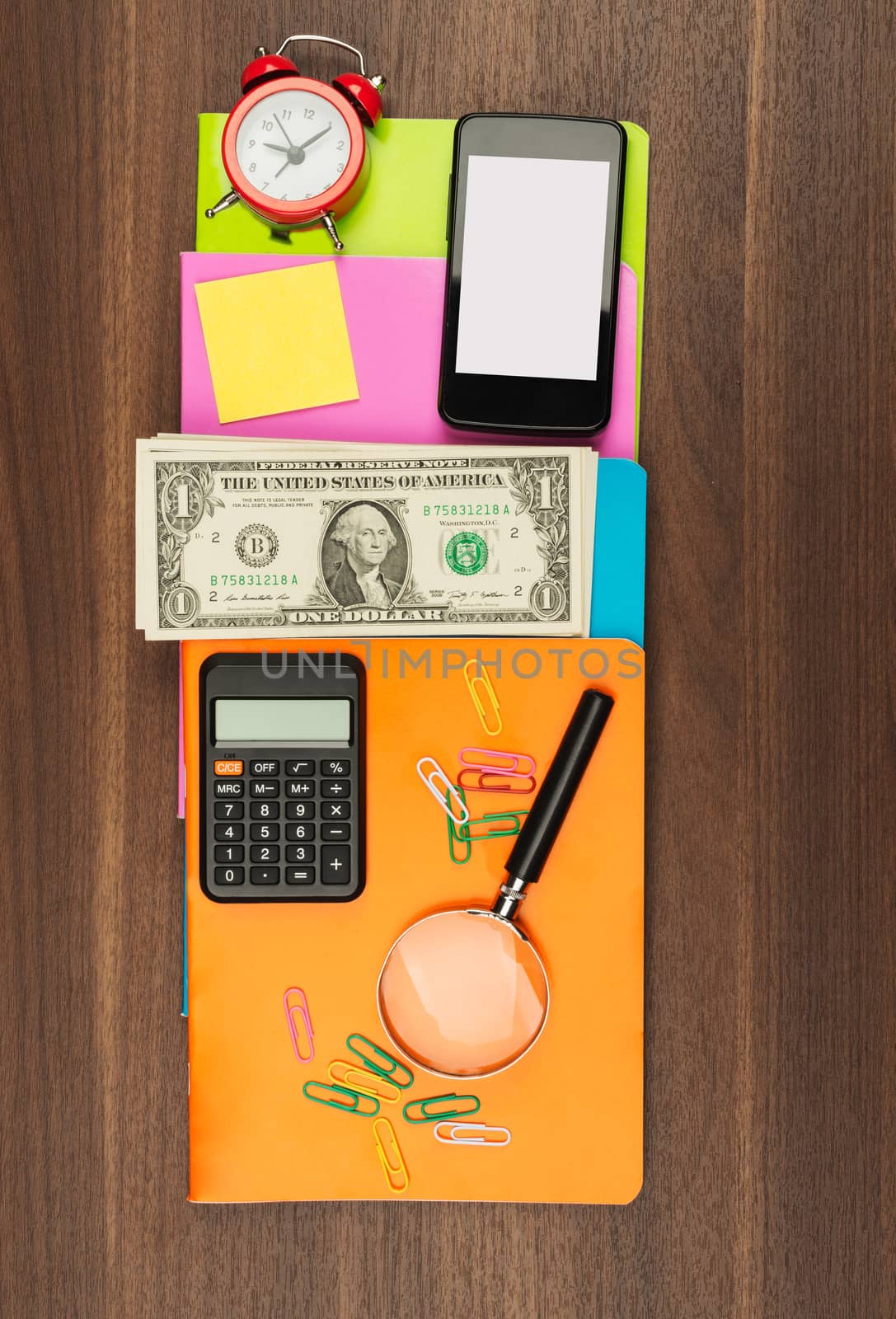 Colorful notebooks with smartphone on wooden table