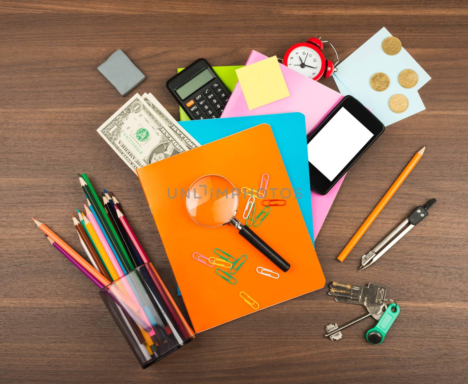 Colorful notebooks with office suppleis on wooden table