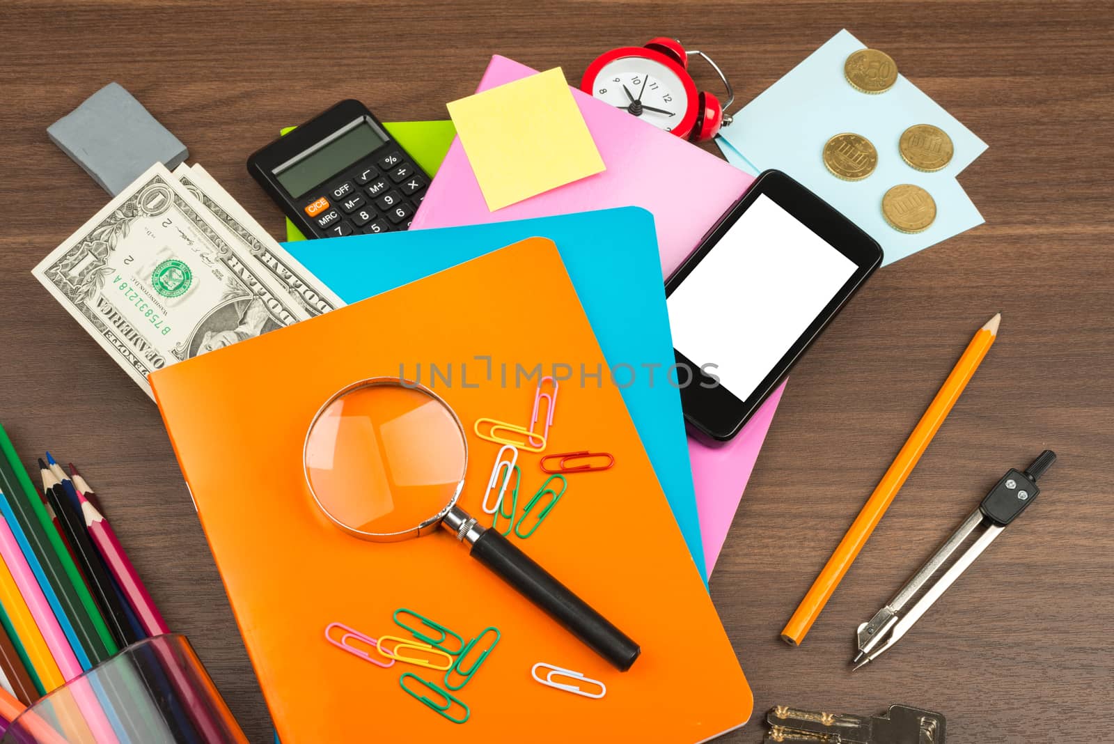 Colorful copybooks with office suppleis on wooden table