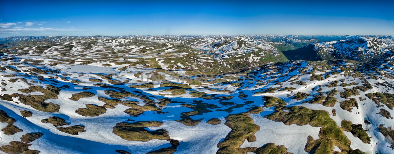 Aerial panorama of norwegian mountains on sunny summer day with perfect visibility