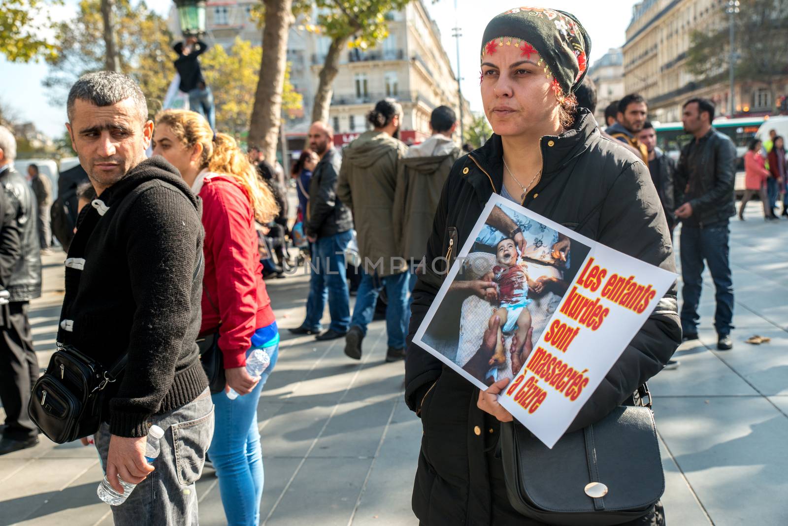 FRANCE, Paris: Two women stand holding a picture of Ankara terror attack while protesters gather in Place de la R�publique in Paris on October 10, 2015, in tribute to the victims of the terror attack. The same day, at least 95 people died after a twin explosion in the center of the capital city in Turkey. 