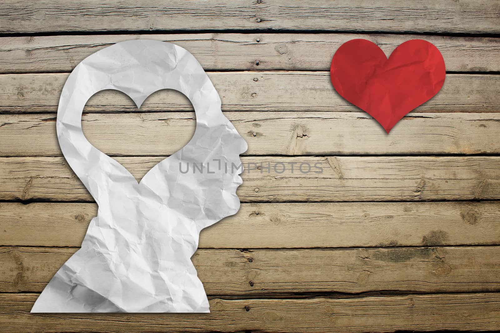 Paper humans head with heart on wood deck background