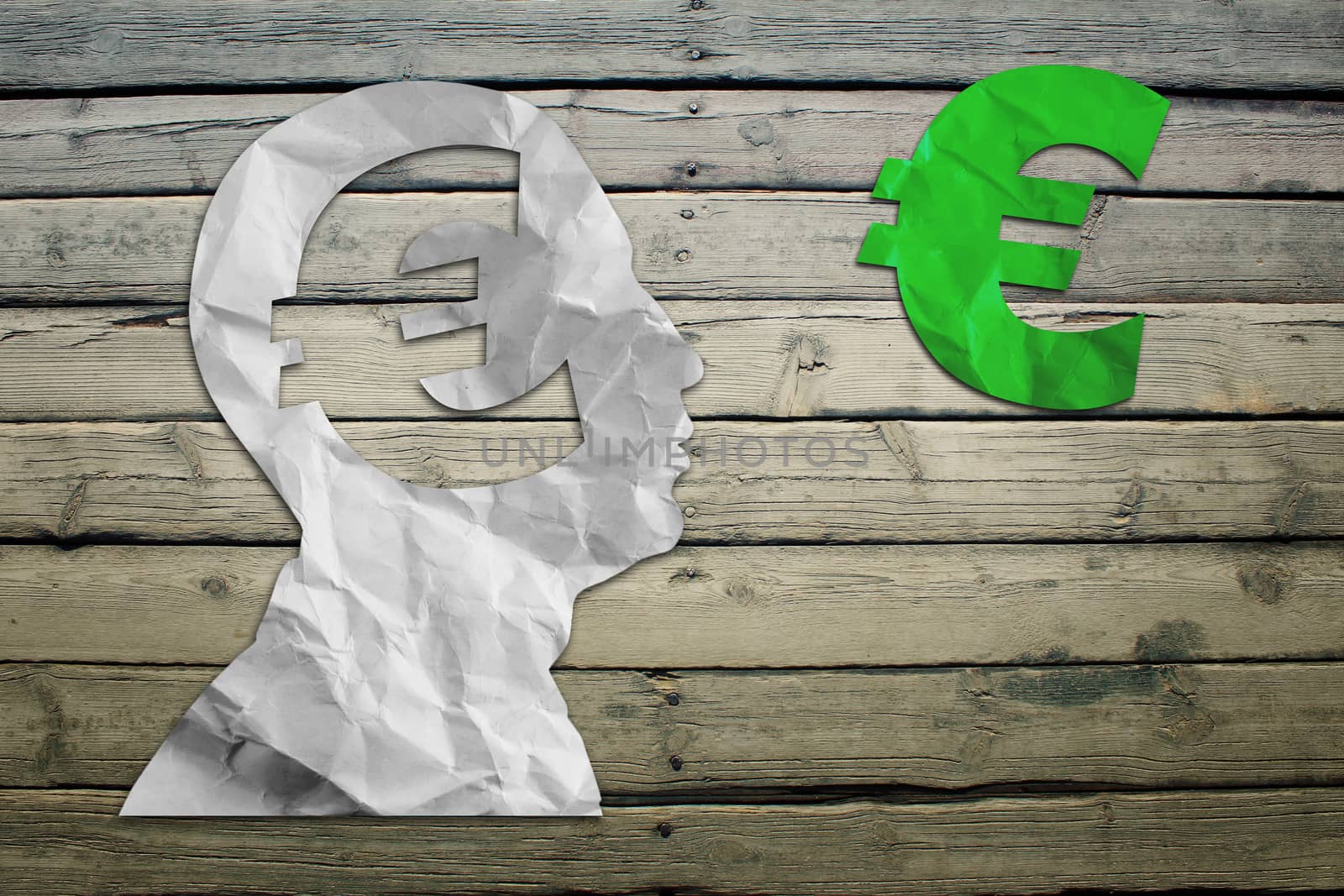 Paper humans head with euro symbol by cherezoff