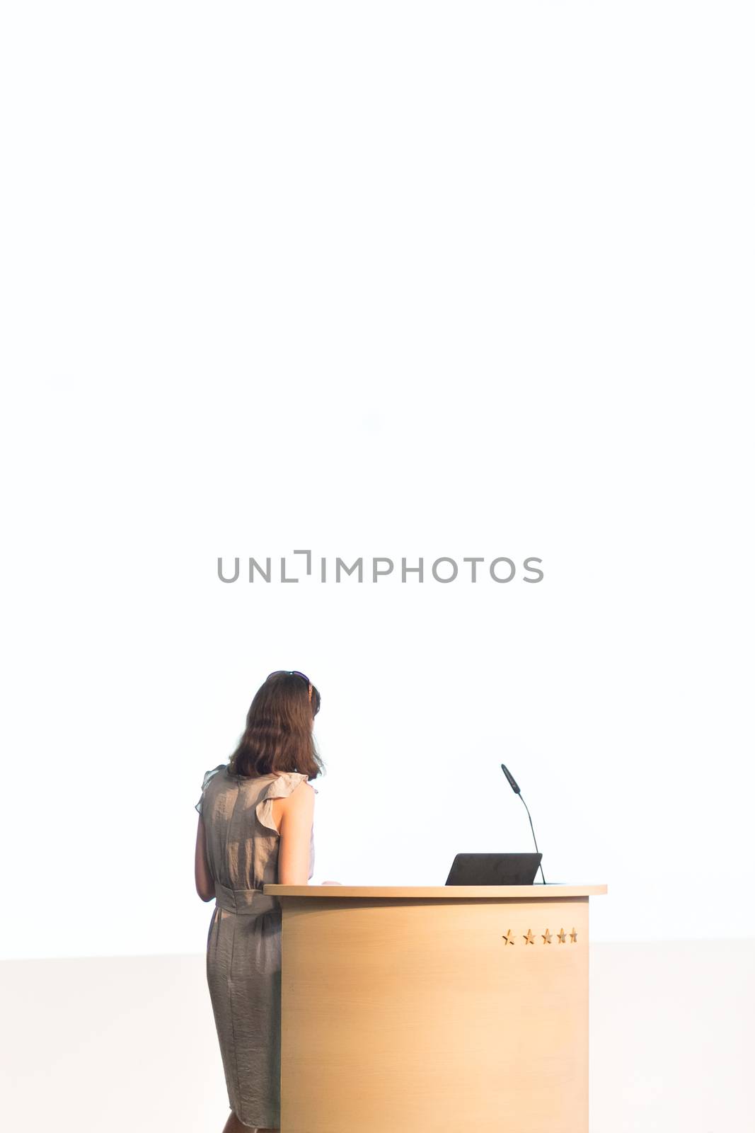 Business woman making business presentation. Female speaker giving a talk at  business conference . Business and Entrepreneurship concept. Brand copy space on white screen.