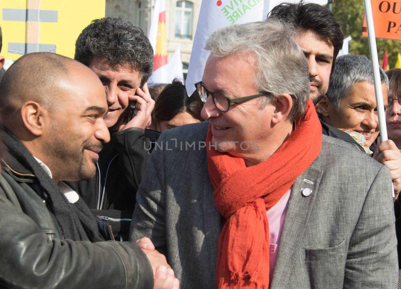 FRANCE, Paris : National head of Communist party Pierre Laurent (R) and SOS Racism head Dominique Sopo shake hands while protesters gather in Place de la R�publique in Paris on October 11, 2015, for the second time after the terror attack in Ankara, in tribute to the victims of the twin explosion in Turkish capital city. On October 11, 2015, at least 95 people died after a twin explosion in the center of the capital city in Turkey. The Turkish government declared three days of mourning and said that it won't delay legislative elections expected for November 1st, 2015. 