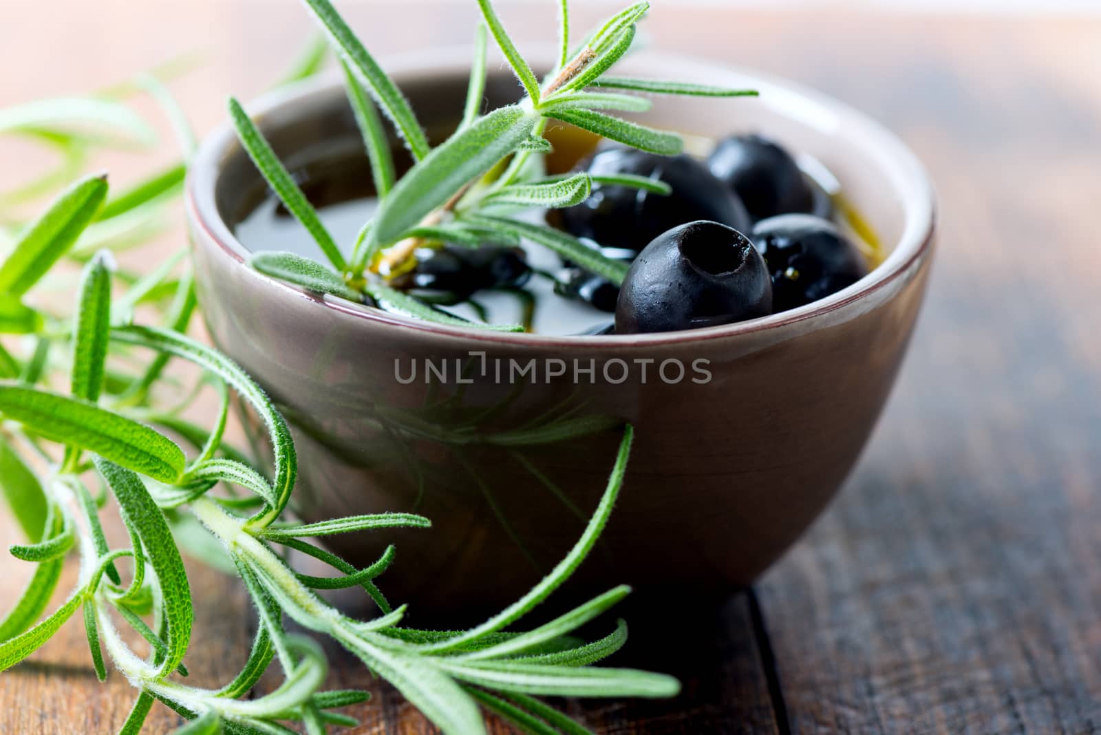Black olives in bowl by Nanisimova