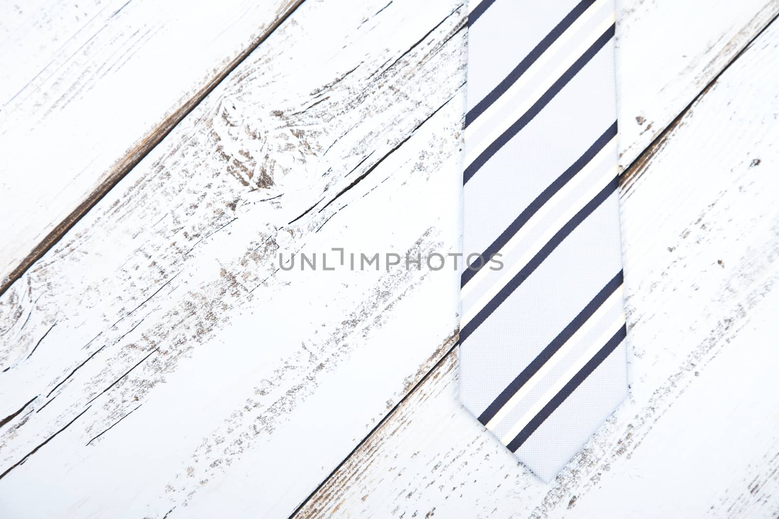 Business tie on light blue wooden background