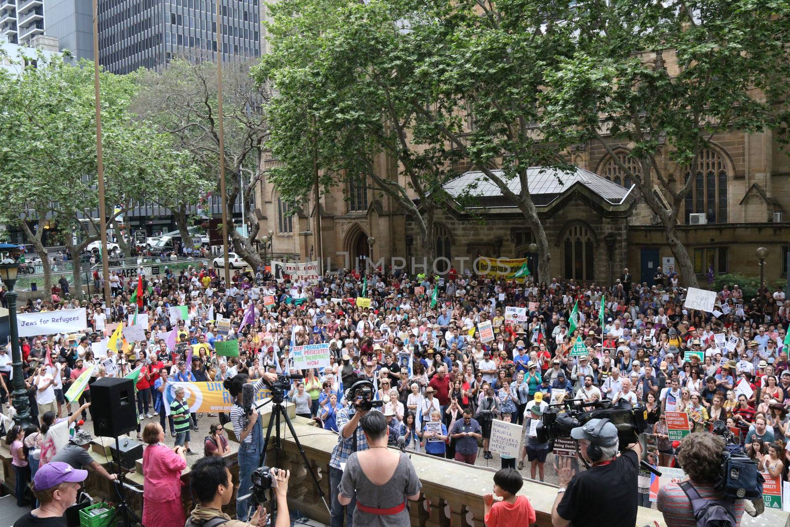 AUSTRALIA, Sydney: #StandUp4Refugees protesters carry signs as they march to Belmore Park after a rally at Sydney Town Hall on October 11, 2015; thousands demonstrate across Australia to support asylum seekers and oppose mandatory detention.