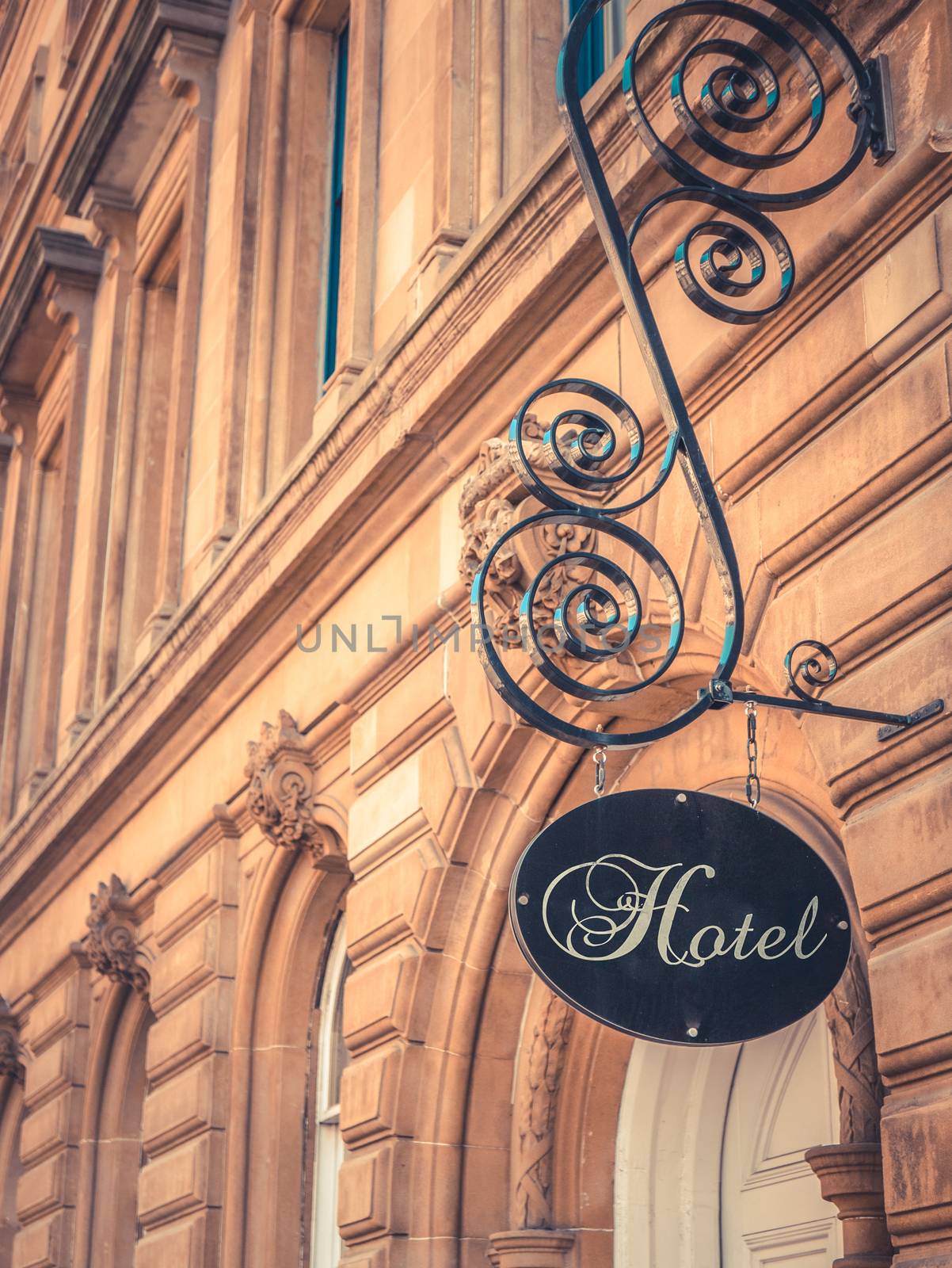 Ornate Sign For Luxury Hotel Outside Beautiful Sandstone Building
