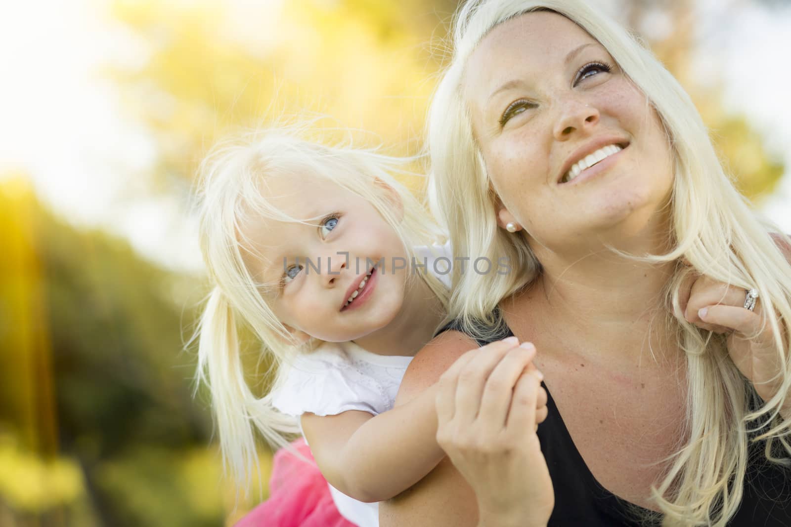 Mother and Little Girl Having Fun Together in Grass by Feverpitched