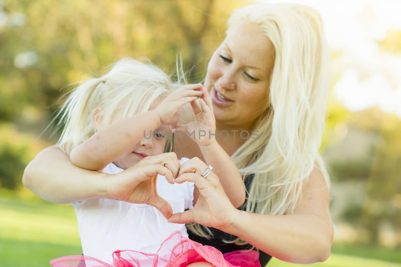 Little Girl With Mother Making Heart Shape with Hands by Feverpitched