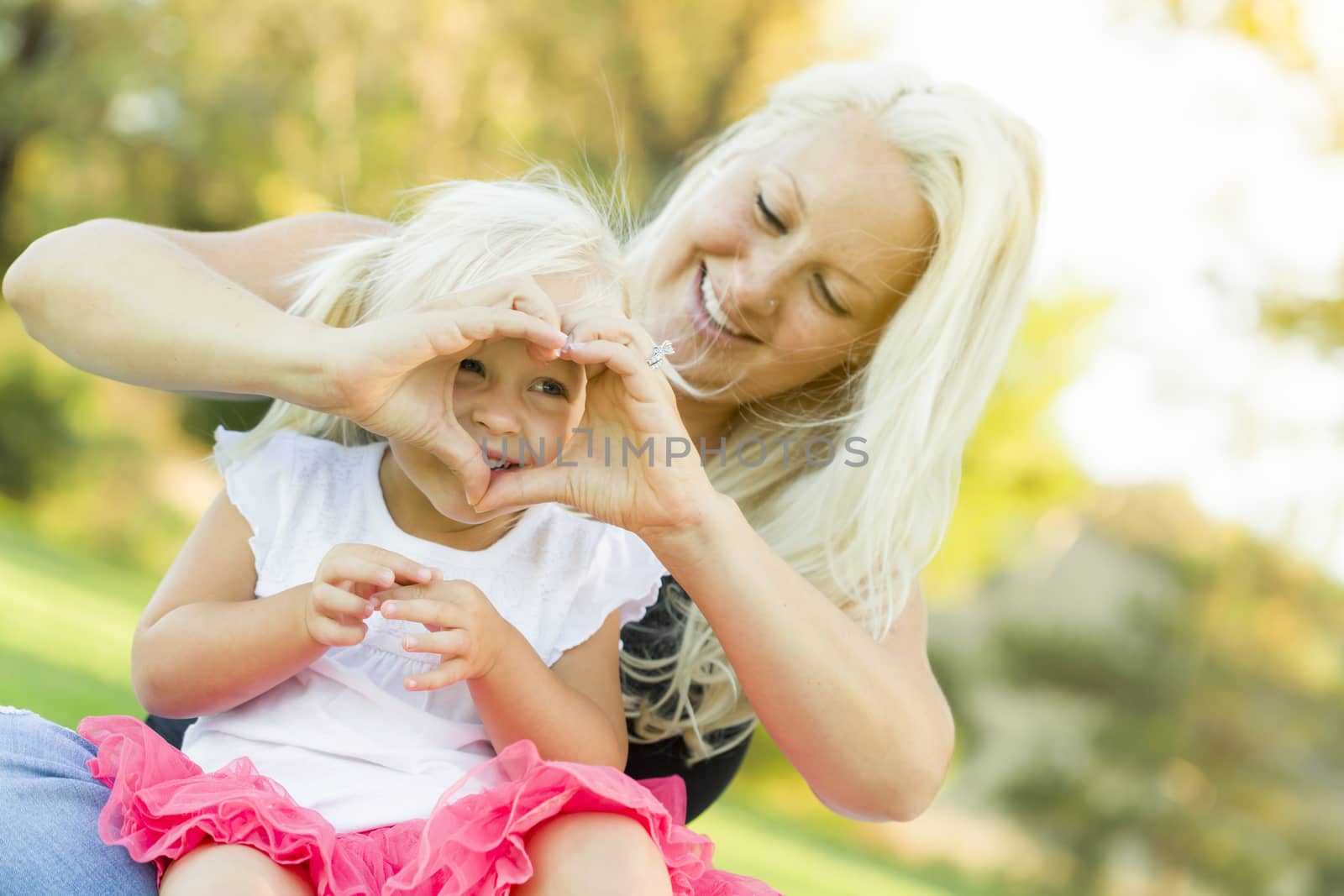 Little Girl With Mother Making Heart Shape with Hands by Feverpitched