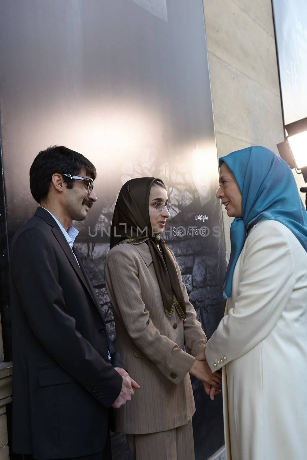 FRANCE, Paris: Iranian politician and President elect of National Council of Resistance of Iran (NCRI) Maryam Radjavi (R) shakes hands with Iranian dissidents Parisa Kohandel (c) and Farzad Madadzadeh (L) during the 2015 World Day Against the Death Penalty, in Paris, on October 10, 2015. The international conference held in Paris on the occasion of the World Day Against the Death Penalty highlighted the surge of executions in Iran and need for urgent action. The Iranian regime has executed more than 120,000 political prisoners in the past 34 years.