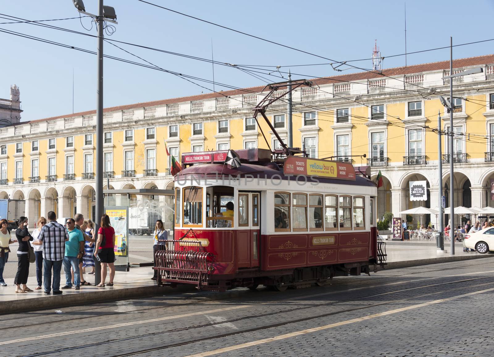 LISBON, PORTUGAL - SEPTEMBER 26: Unidentified people sitting in the red tram  goes by the street of Lisbon city center on September 26, 2015. Lisbon is a capital and must famous city of Portugal