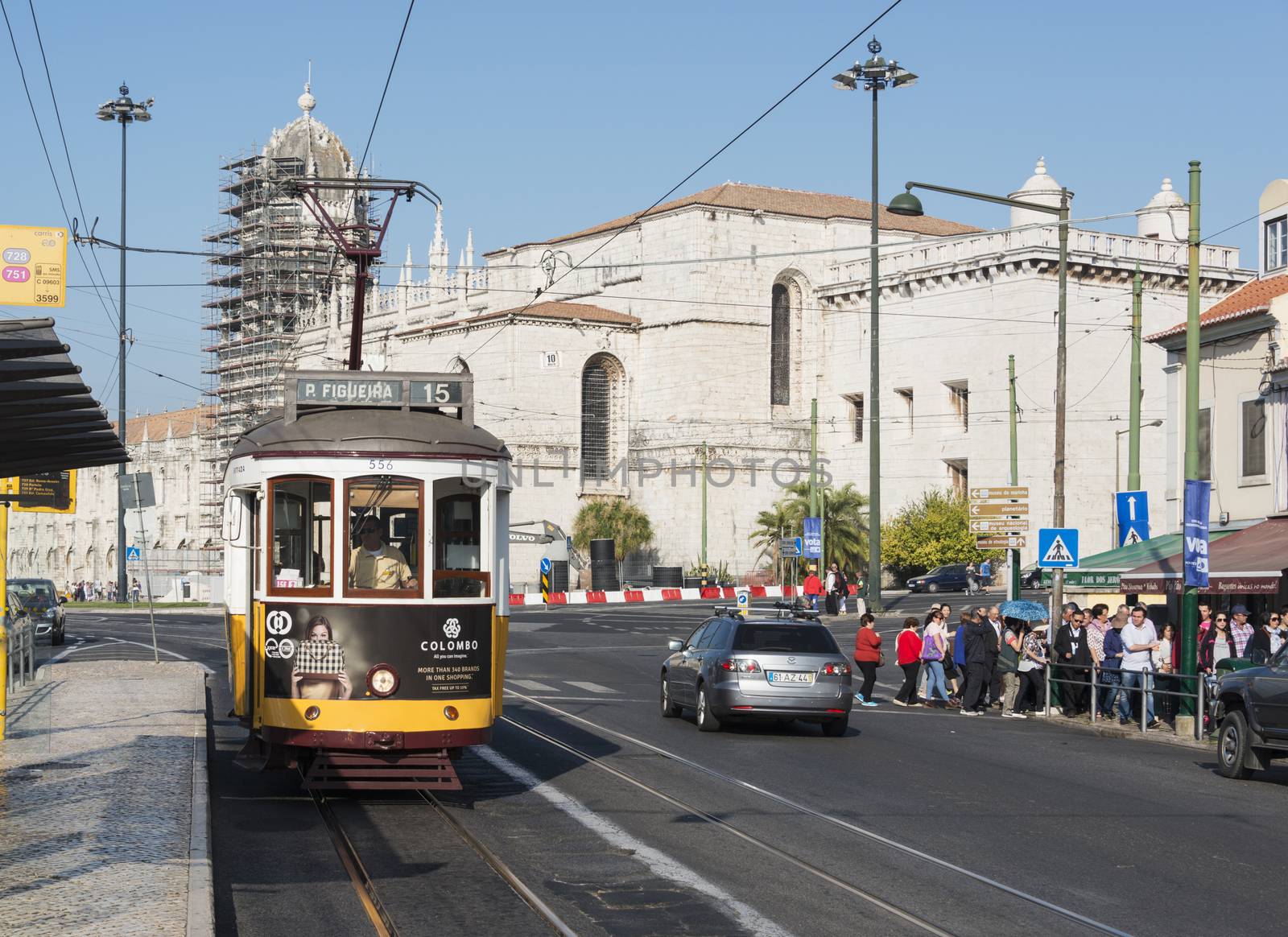 LISBON, PORTUGAL - SEPTEMBER 26: Unidentified people sitting in the Yellow tram  goes by the street of Lisbon city center on September 26, 2015. Lisbon is a capital and must famous city of Portugal