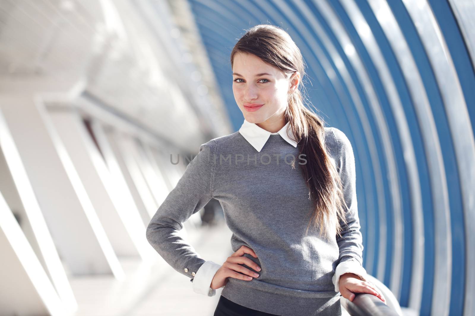 Young Businesswoman standing in corridor of modern office building