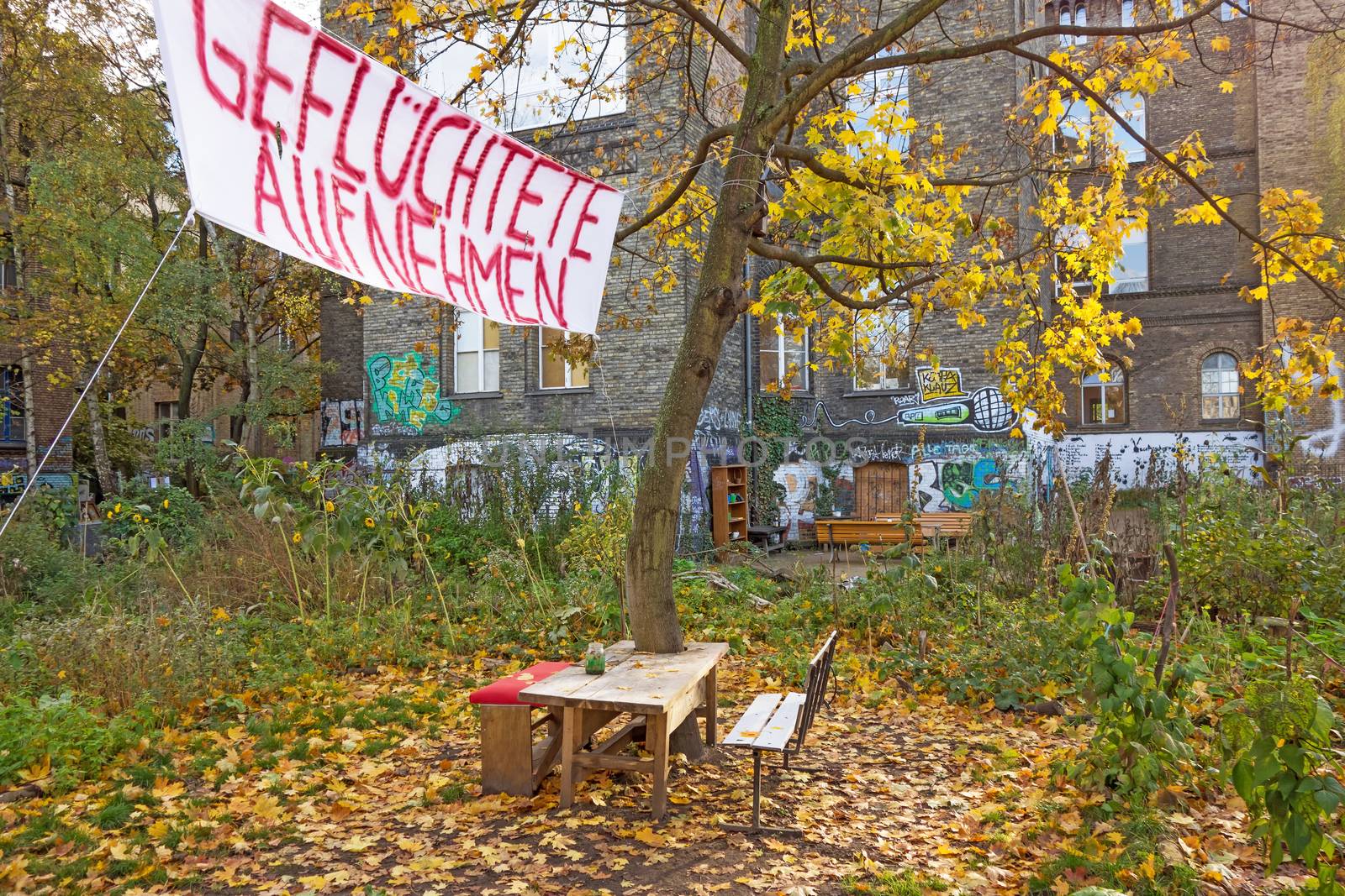 Berlin, Germany - October 26, 2013: Banner inscribed with "Admit Refugees" (Gefluechtete aufnehmen) - in a less wealthier neighborhood of Berlin, Germany.