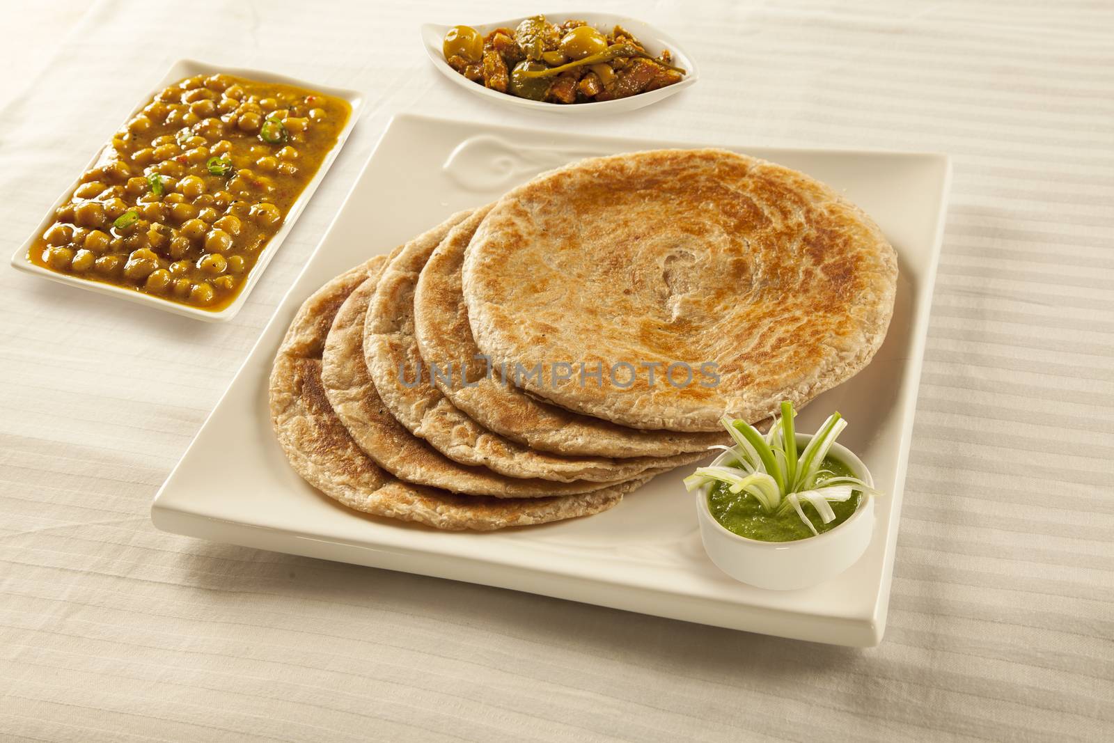 Bran paratha puri served with chickpeas cholay and pickle chutne by haiderazim