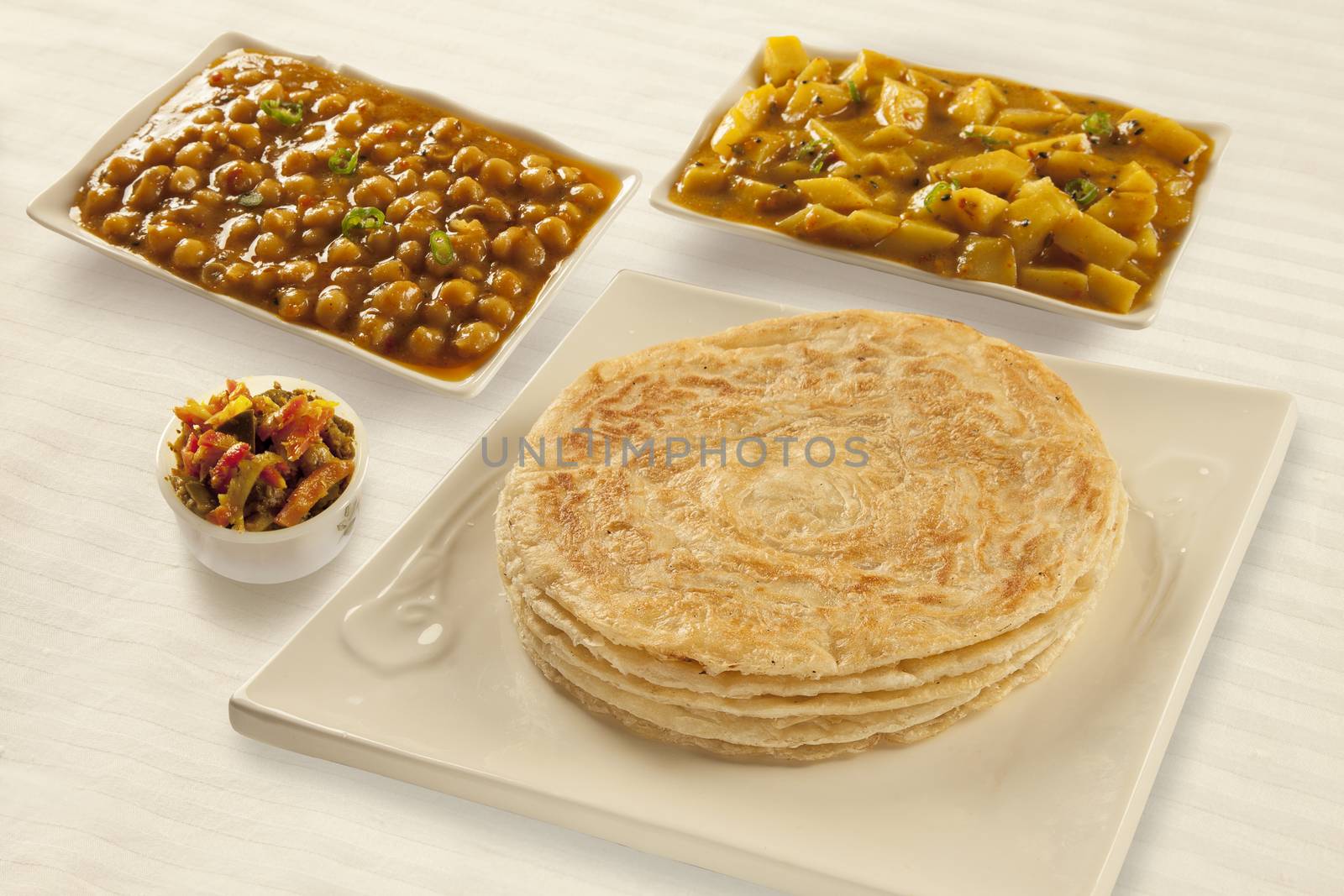 Puri paratha with chickpeas potato curry and pickels  by haiderazim