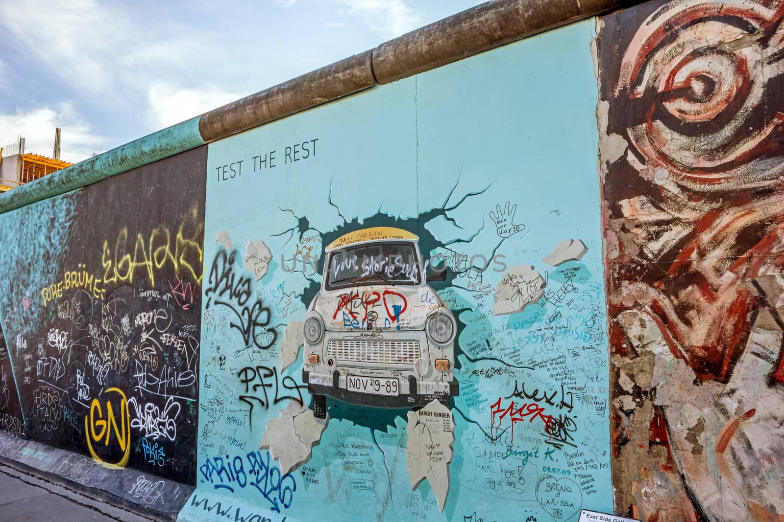 Berlin, Germany - October 26, 2013: the murial titled "Test the Rest" by Birgit Kinder on a remnant of the Berlin Wall, East Side Gallery, Berlin.