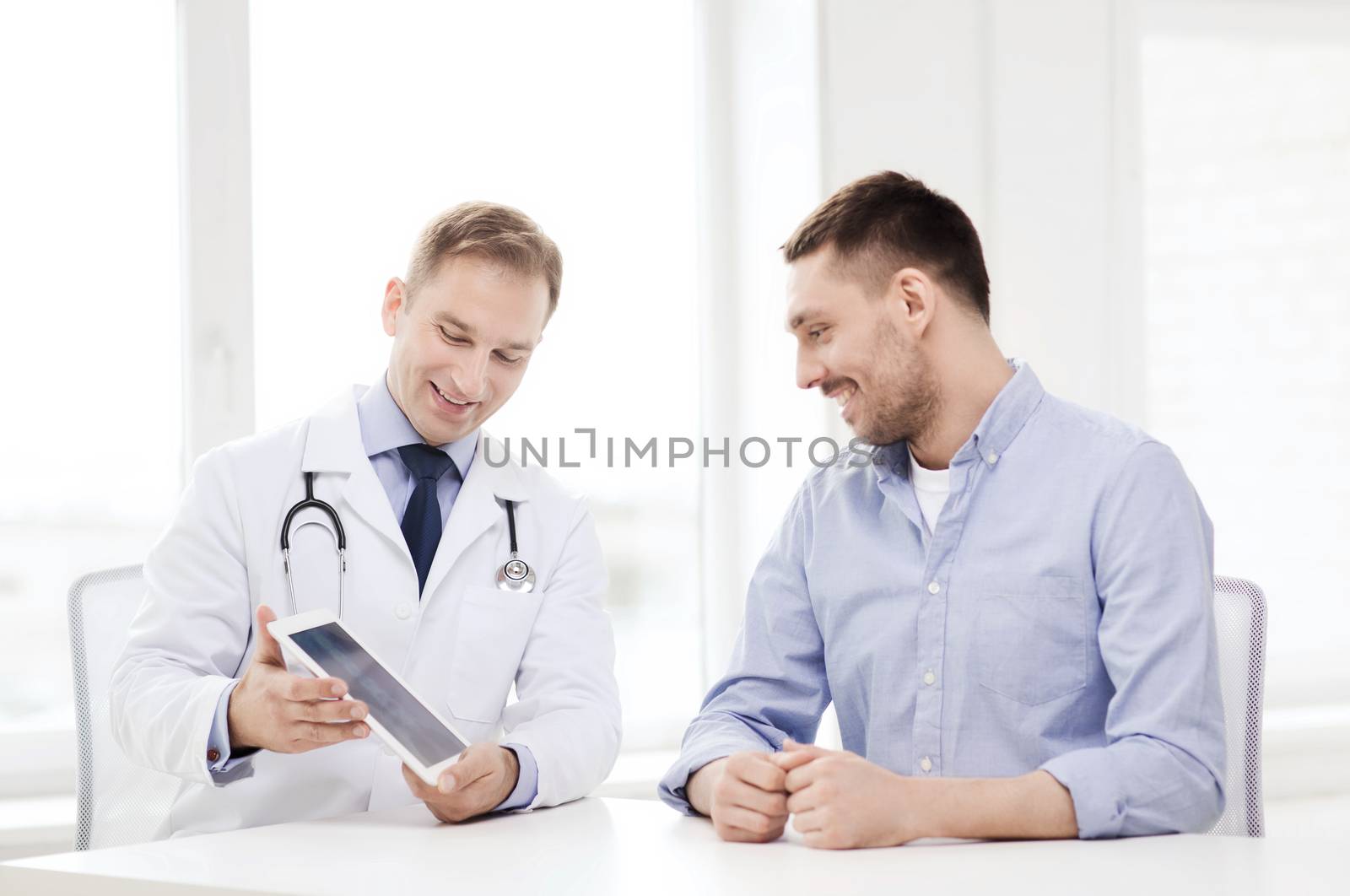 healthcare, technology and medicine concept - smiling doctor with tablet pc computer and patient in hospital