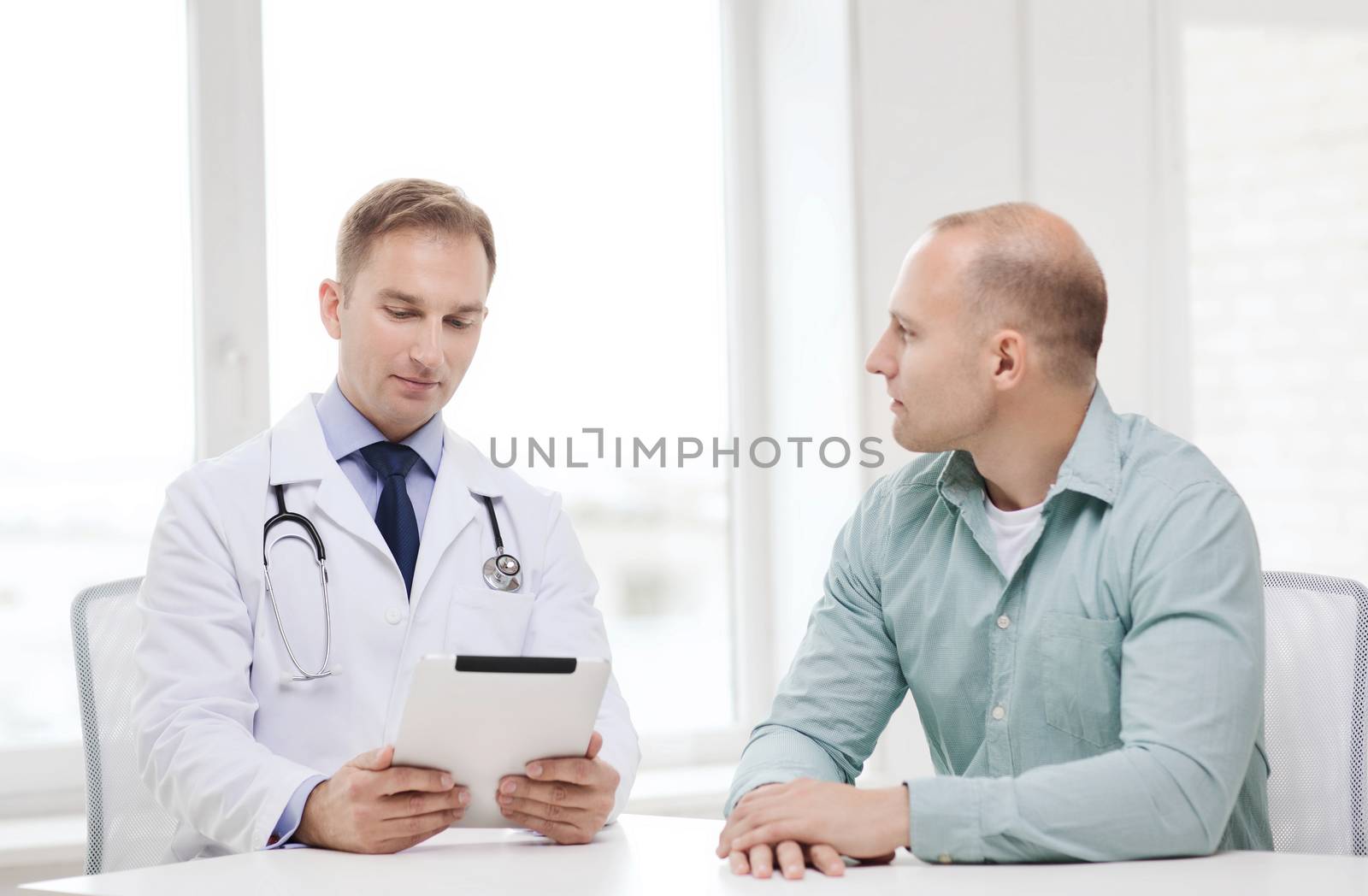 doctor with tablet pc and patient in hospital by dolgachov