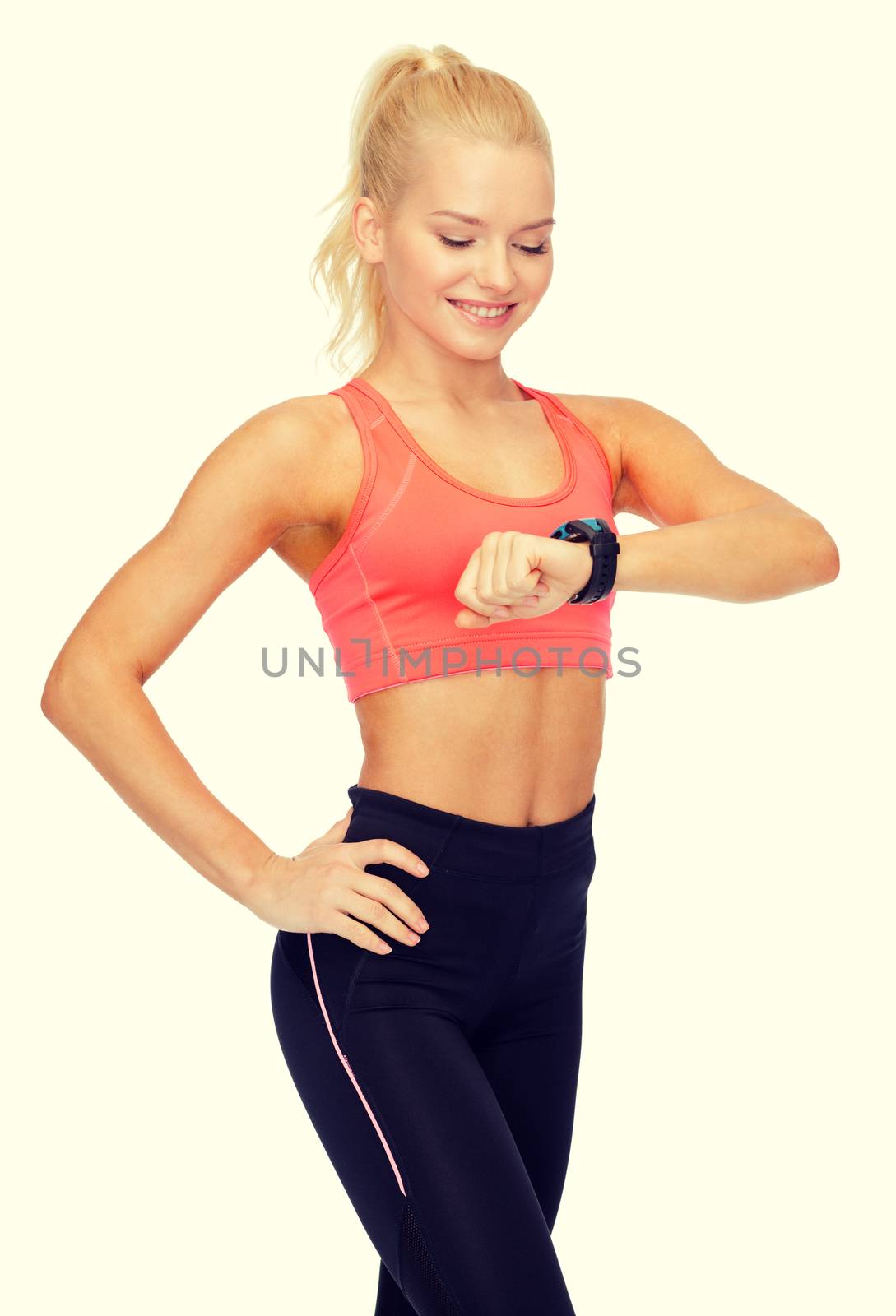 fitness, technology and exercising concept - smiling woman looking at heart rate monitor on hand