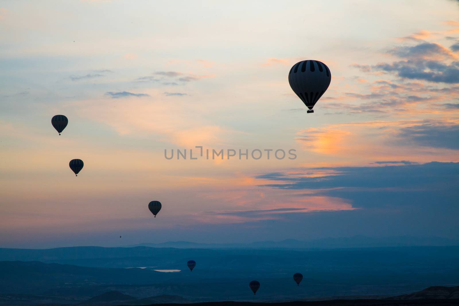 Hot air balloons in silhouette sunrise at the background