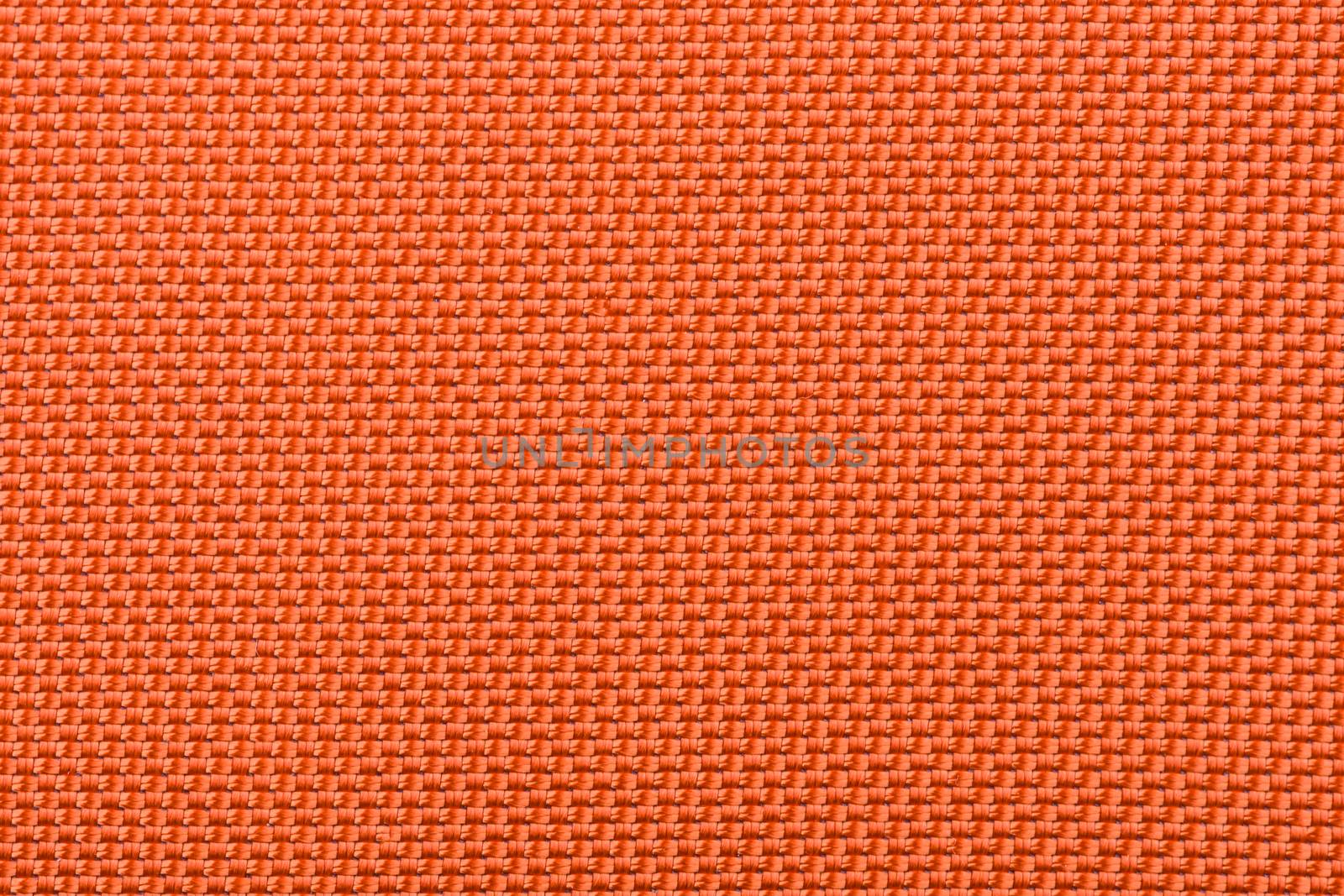 A macro shot of a very tightly woven orange fabric.