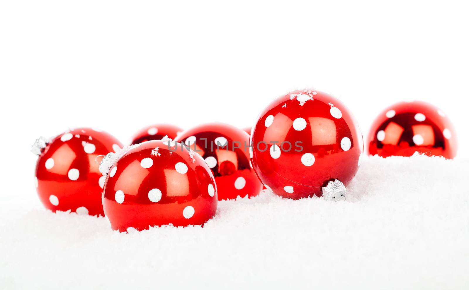 red polka dot Christmas bauble, isolated over white