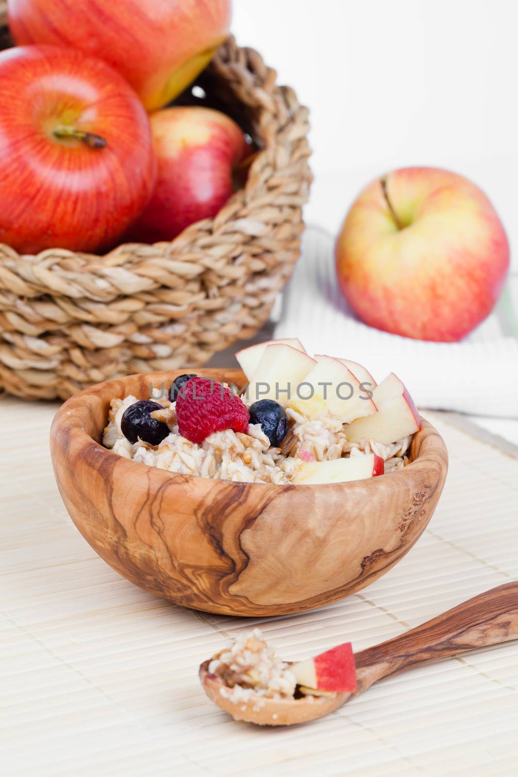 Healthy bowl of muesli, apple, fruit and milk for a nutritious b by motorolka