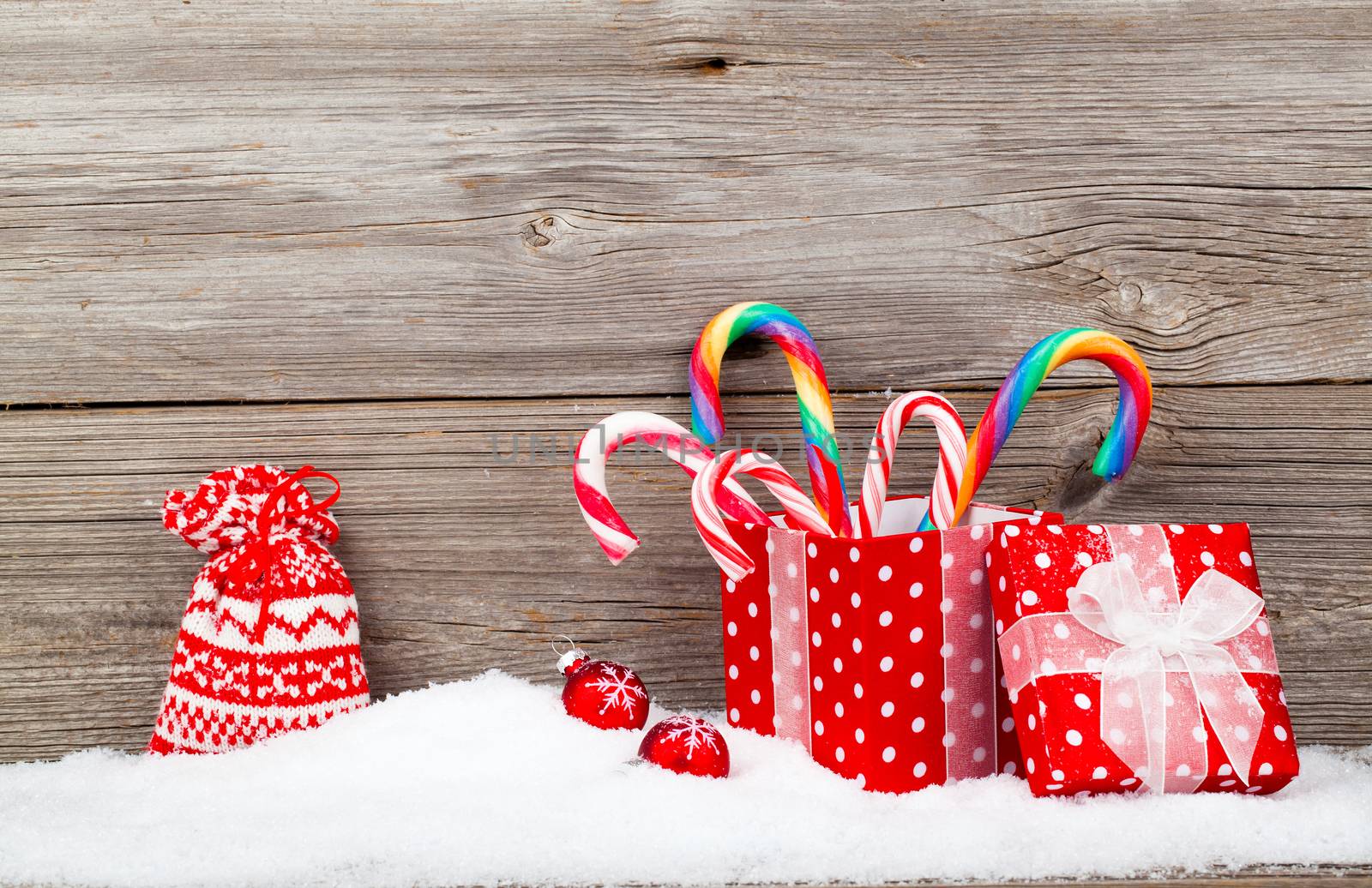 Christmas decoration with xmas canes, over wooden background