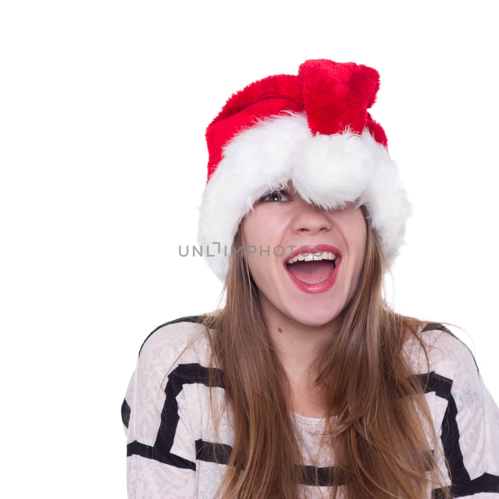 Portrait of joyful pretty woman in red santa claus hat laughing isolated on white background. Beautiful girl looking happy and excited. Happy Christmas and New Year holidays full of fun.