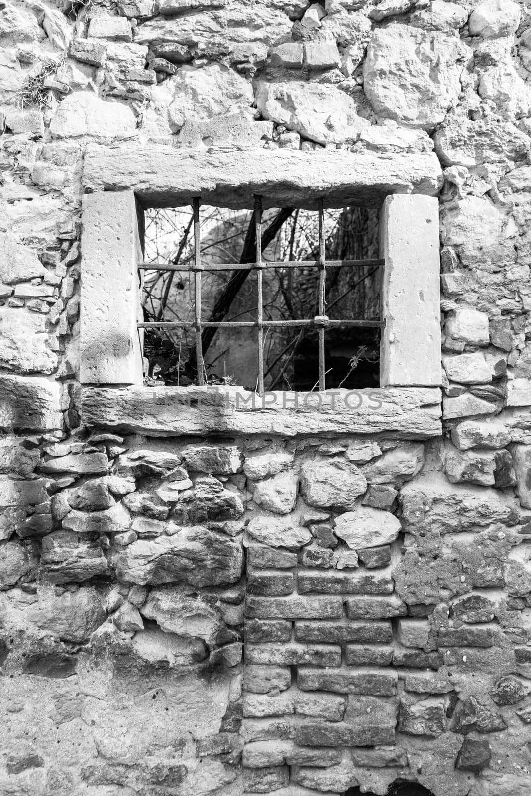 old window grille of a ruined castle in Italy